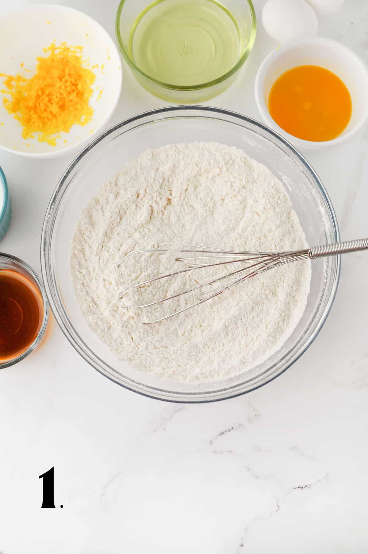 How to Make Cranberry Orange Muffins - Step 1 - combining dry ingredients in bowl.