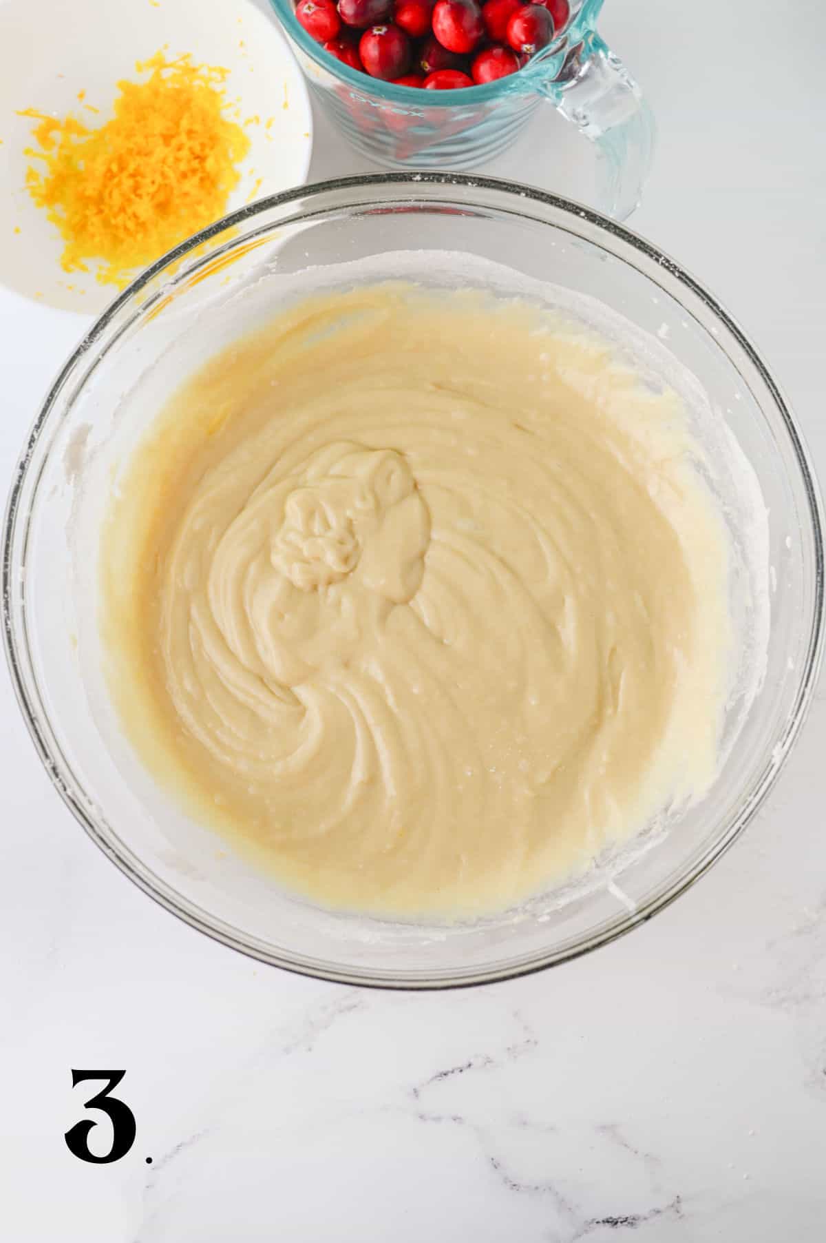 How to Make Cranberry Orange Muffins - Step 3 mixing wet and dry ingredients.