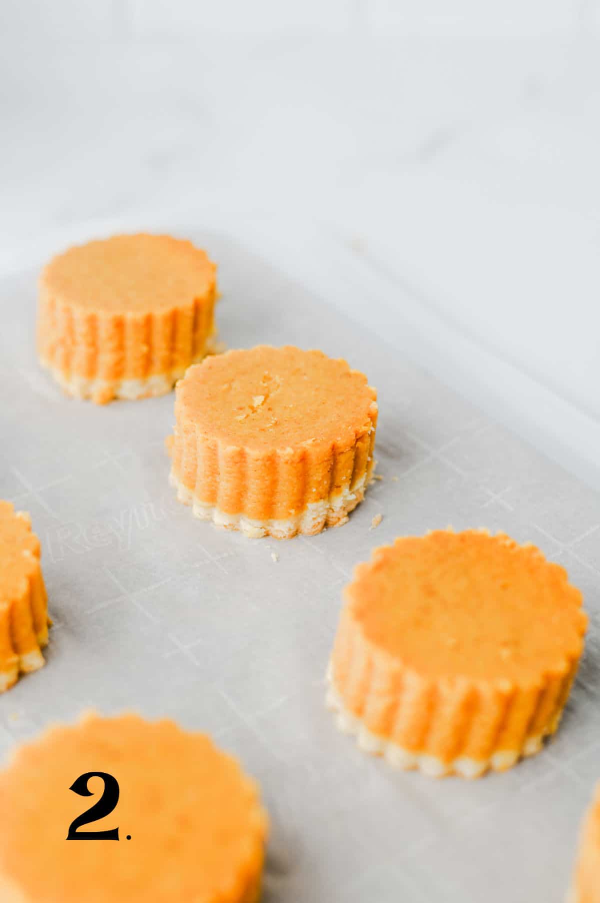 How to Make Pumpkin Pie Bites Step 2 - place mini cakes on sheet.
