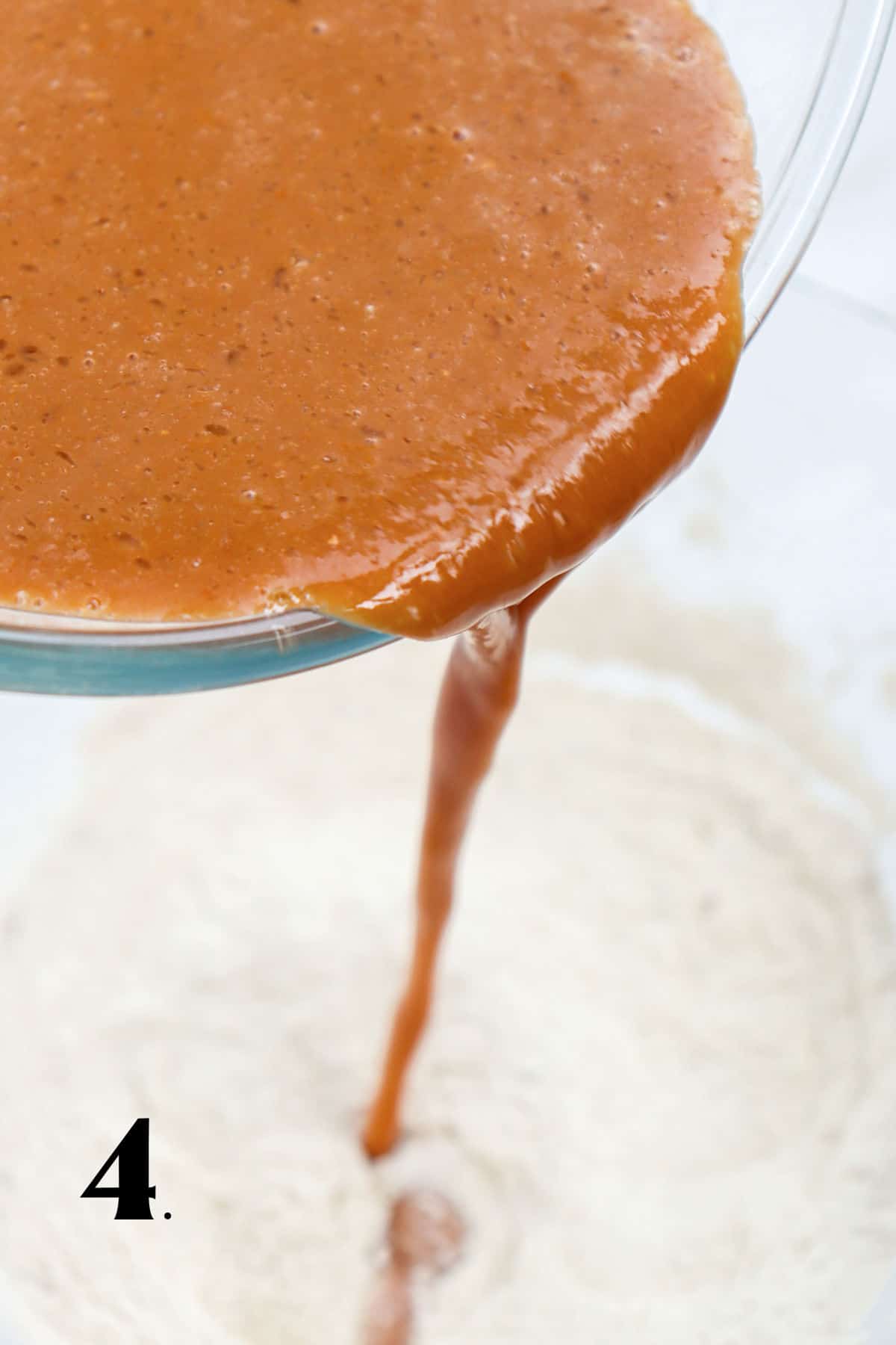 How to Make Pumpkin Waffles Step 4 - mixing pumpkin with dry ingredients in bowl.