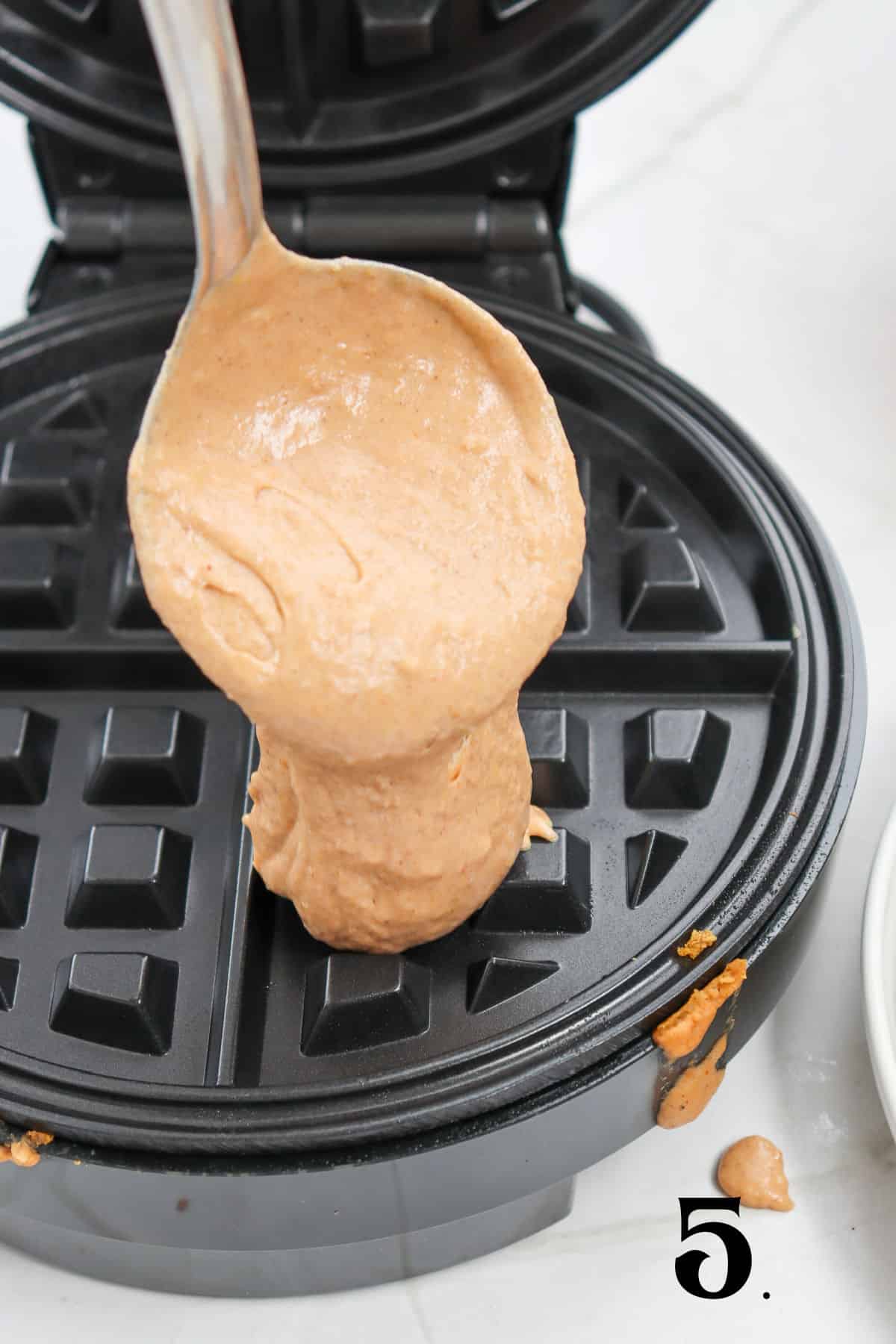 How to Make Pumpkin Waffles Step 5 - pouring batter into waffle iron.