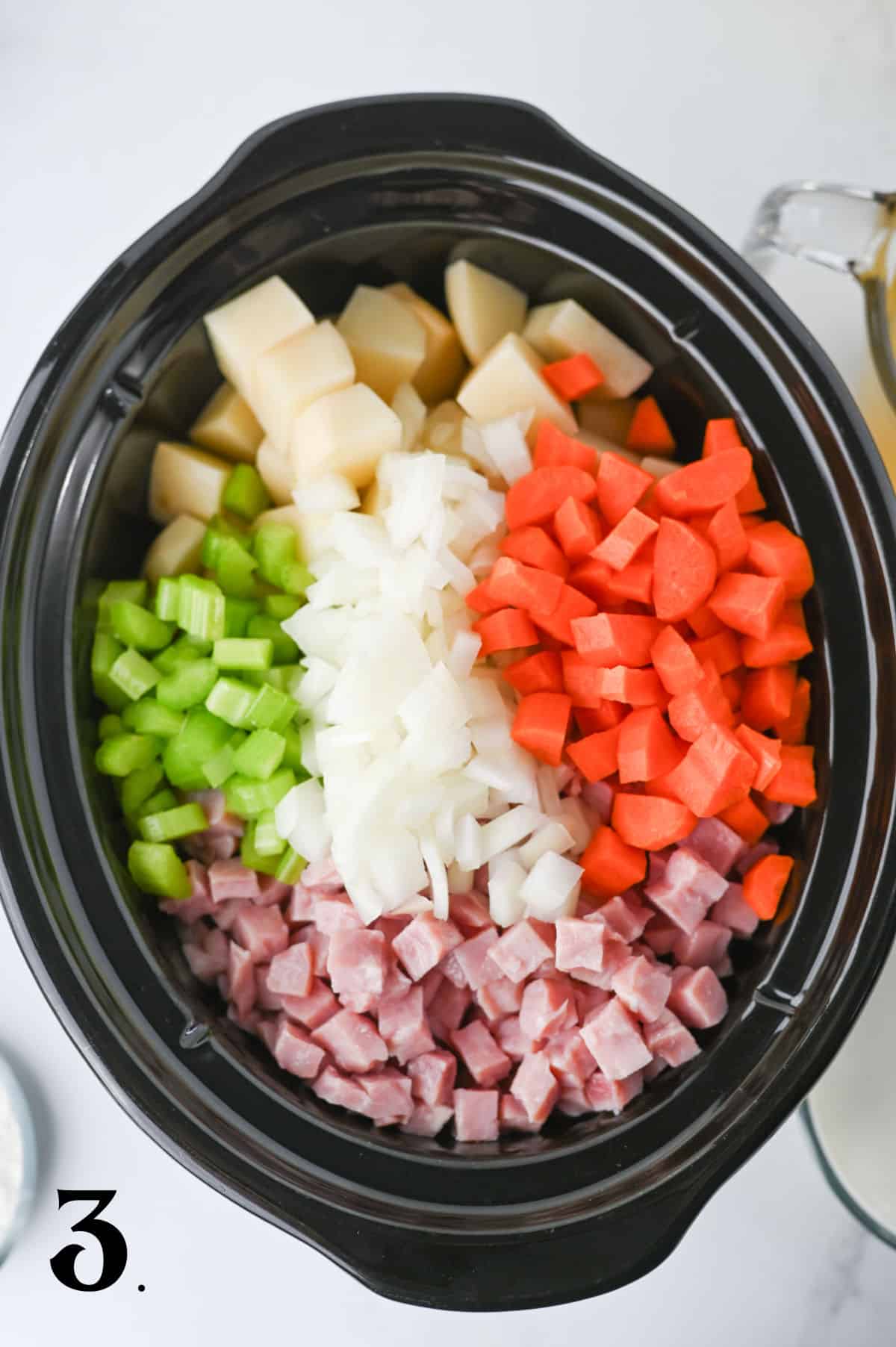 How to Make Slow Cooker Ham and Potato Soup Step 3 - adding onions, celery and carrots.