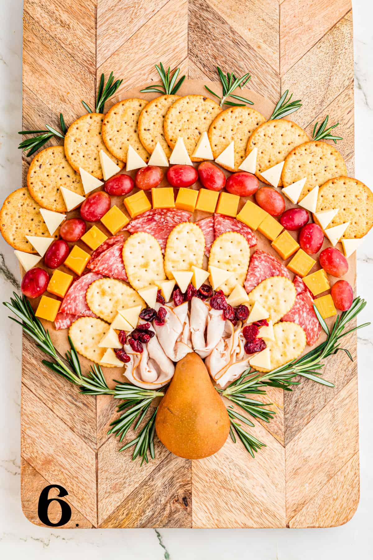 How to Make a Thanksgiving Turkey Charcuterie Board - Step 6 add greenery.