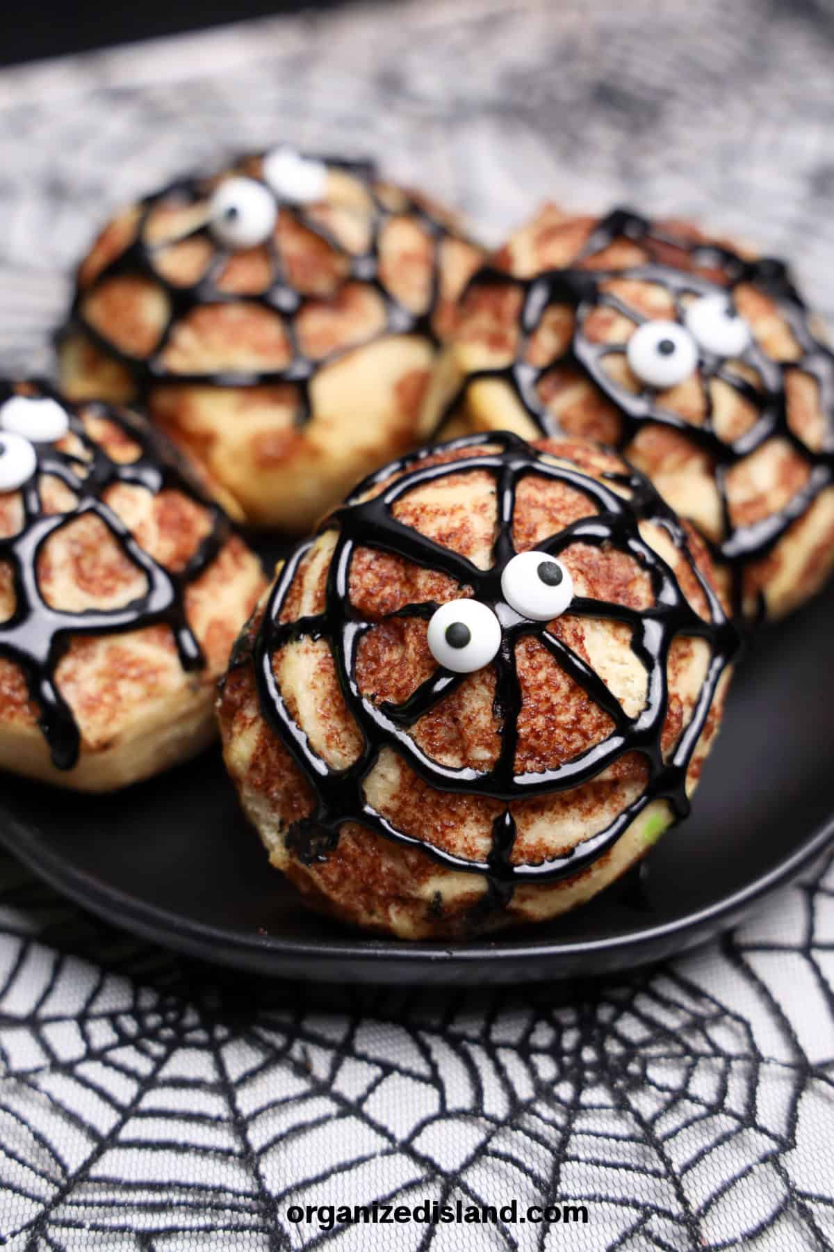 Spider Cinnamon Rolls on plate.